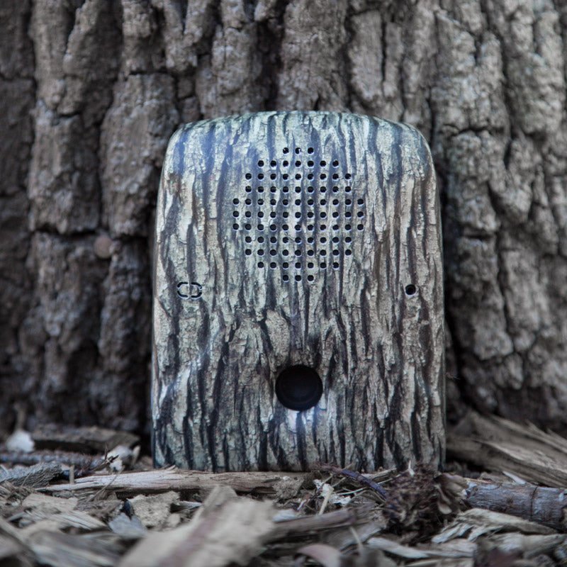 Dog Silencer MAX with tree bark faceplate against a tree